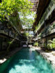 outdoor swimming pool surrounded by tropical greenery at outpost ubud hotel